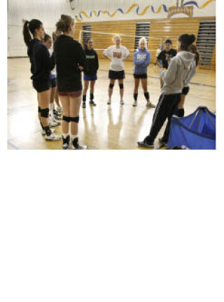 The Bainbridge Spartans volleyball team chats before practice Thursday to discuss its season-ending games this weekend.