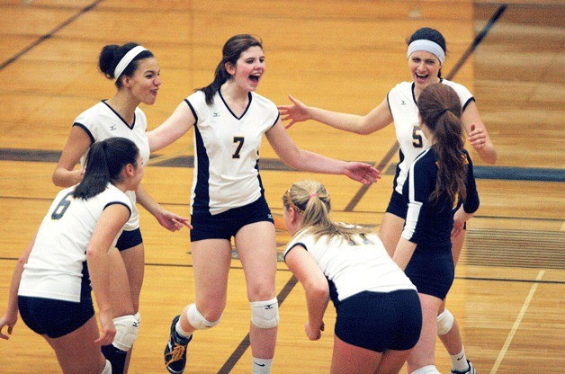 The Spartans gather to celebrate after winning a point in their second-set comeback against Lakeside.