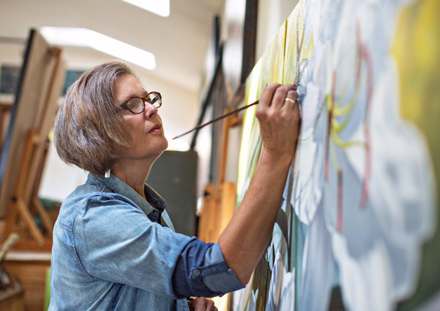 Claudia McKinstry at work. Her paintings take center stage at Bainbridge Arts & Crafts in July.