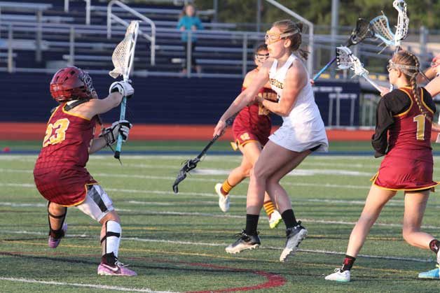 Bainbridge’s Ellen Carpenter sends a shot past the Lakeside goalie during the Spartans’ 16-2 win over the Lions.