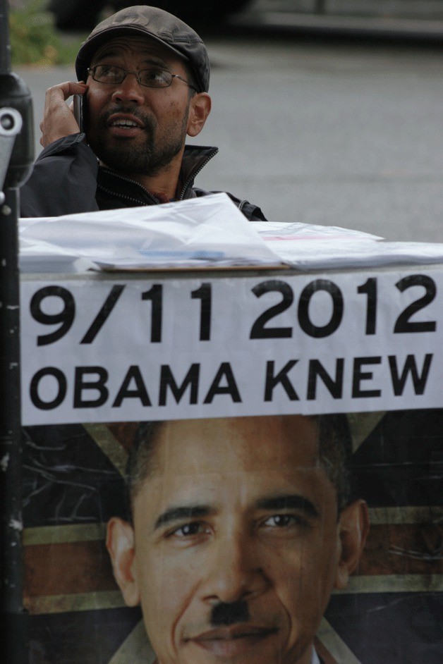 A supporter of Lynden LaRouche sits at a small display on Winslow Way Saturday. The man