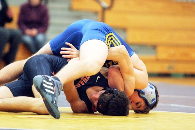 Liam Topham of Bainbridge High pinned Tanner Eggert of Eastside Catholic in 1:50 in the 138-pound class.