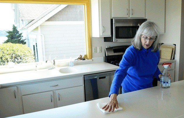 Katherine Kennedy wipes down the counter of her Skiff Point vacation rental