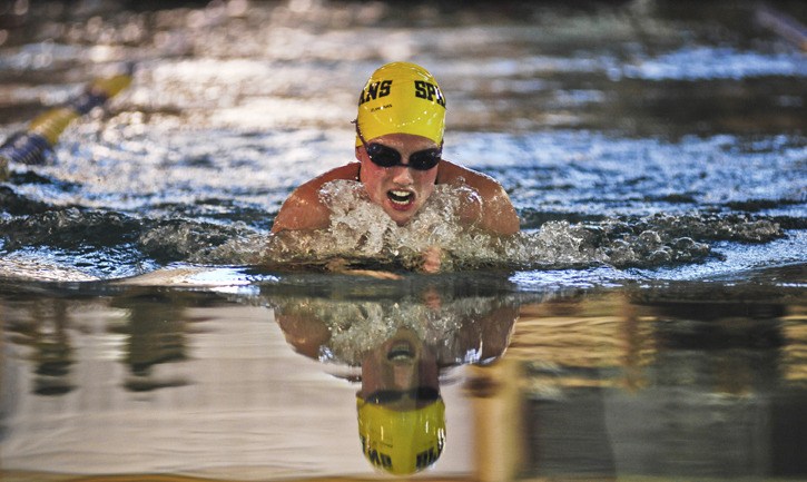 Spartan senior Tess Harpur rides high on the water during her win in the 100-yard breaststroke race against Mercer Island.