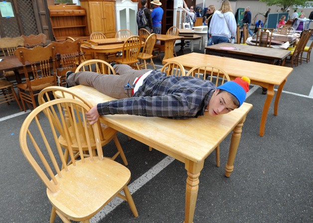 Sky Harvesty of Poulsbo landed on a table after sprinting to the furniture section at the 50th annual Rotary Auction and Rummage sale Saturday at Woodward Middle School.