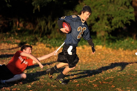 Travis Quick attempts to pull the flag on runner and quarterback Zach Anderson Monday during a pick up flag football game at Gideon Park. The players are from the Bainbridge Bible Chapel and meet regularly at the park.