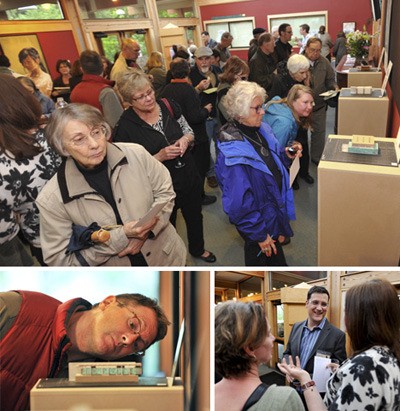 Brad Camp/For the Review Top: More than 150 citizens gathered at Bainbridge Performing Arts Monday night to view models for the new Bainbridge Art Museum to go on the corner of State Route 305 and Winslow Way. Below: Architect Matthew Coates discusses the models with several people at Monday night’s gathering. Below left: Islander Aaron Levine looks over concept No. 7 of designs for the Bainbridge Art Museum.