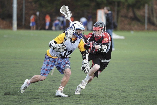 Bainbridge High School senior Sean Maier (left) makes a move past a defender during this year’s Space Needle Shootout.