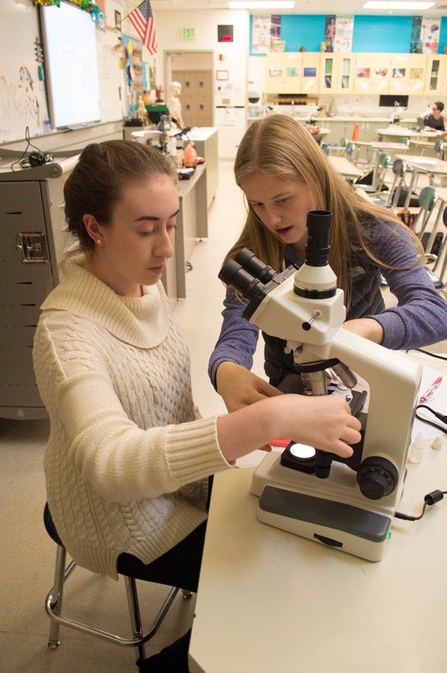 BME officers Leah Potter and Ashley Alnwick take a look under the club’s new microscopes during a malaria lab earlier this month.