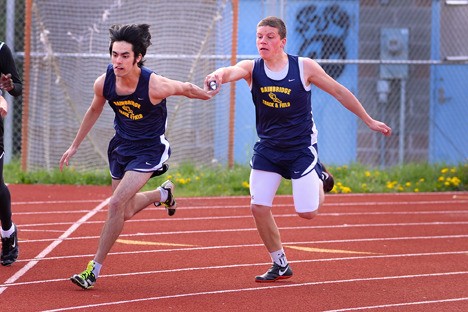 BHS’ Jannik Lutz hands the baton to anchor Drew Wickens during the Spartans’ home meet against Franklin and Bishop Blanchet on April 22. Wickens is tied for fourth in the Metro League in the high jump with a personal best of 5-8.