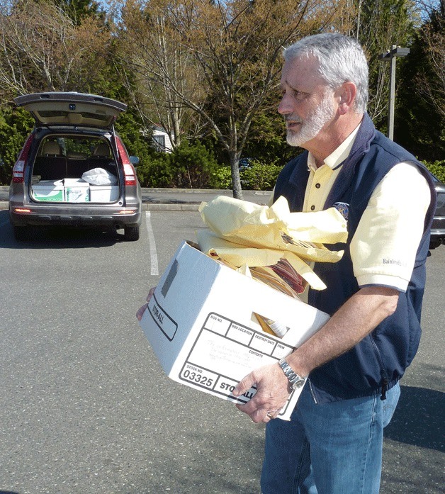 A visitor to last year's ShredFest brings a boxful of documents to the annual Kiwanis fundraiser.