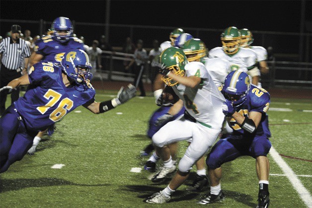 Spartan Ryan Comstock rushes in to help Matt Stone take down wide receiver Jacob Wheatley of the Braves.