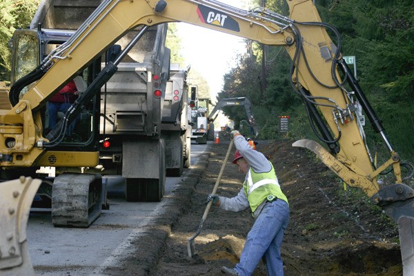 Brad Baselt of Ace Paving of Silverdale is on the front lines of the shoulder widening project now under way on North Madison Avenue between State Route 305 and Valley Road. The project will widen the east side of the road by about six feet.