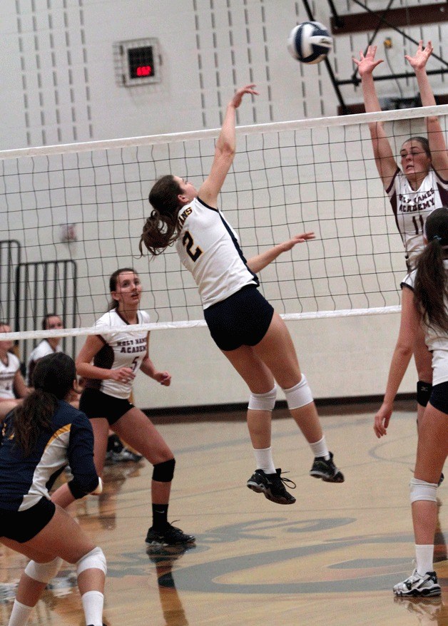 BHS junior volleyball player Riley Kulfan got up high to send the ball back at the visiting team from Holy Names Academy Monday.