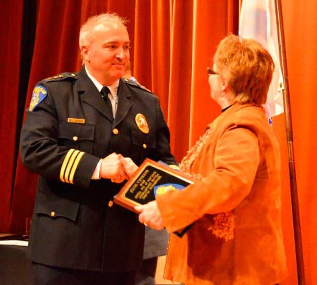 Chief Matthew Hamner presents Barbara Seitz with the Civilian of the Year Award at a recent departmental ceremony.