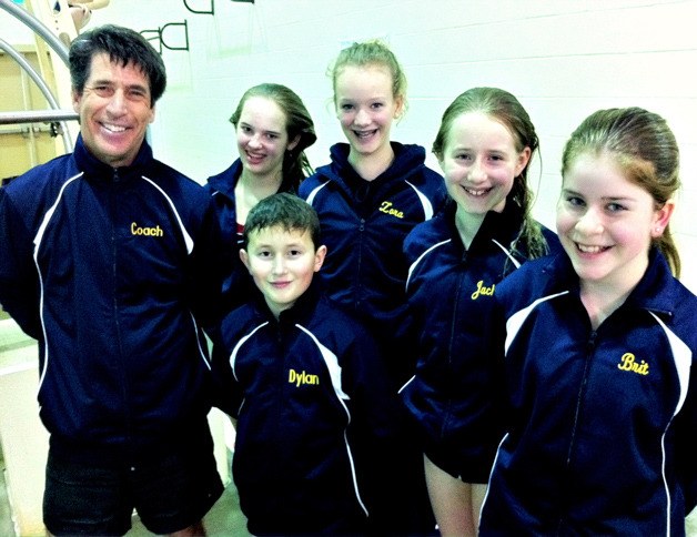 Coach Chris Miller stands with the winning divers from the Bainbridge Island Diving Club; Cammy Rouser