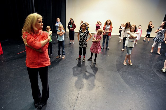 Choreographer Shannon Sheehan runs 28 hopefuls through dance numbers Wednesday during auditions for Annie.