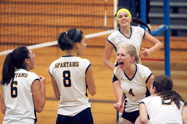 Rowan Atherley reacts with joy after the Spartans launch a comeback against the Cougars in Metro League Volleyball action earlier this week. At top left