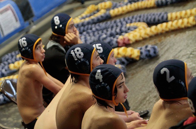 The Spartans watch as their teammates work toward another win in action against Stadium. The Bainbridge water polo team is on a tear early this season