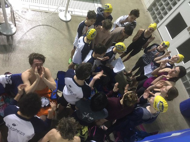 Members of the Bainbridge Island Swim Club give a team cheer before the Northwest Championships.