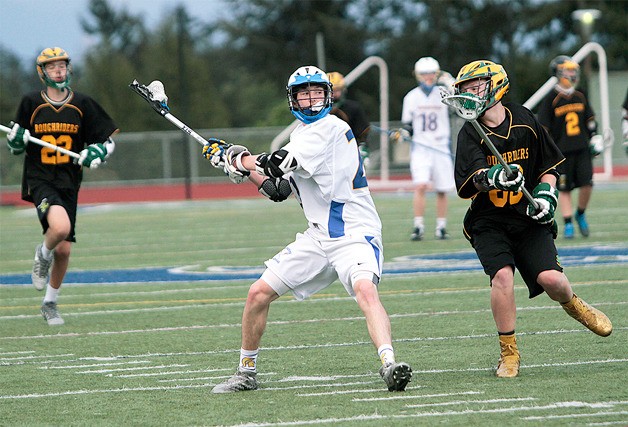 BHS sophomore Ethan Peloquin looks to pass to an open teammate during Friday night’s home match. The Spartans sailed easily to a 24-0 shutout win.