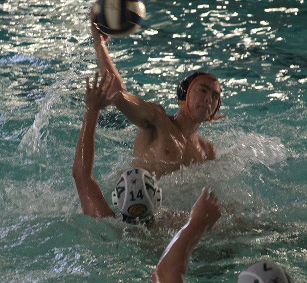 Harrison Shinohara pulls back for a shot at the goal during the varsity boys water polo team's recent home match against Peninsula Oct. 14.