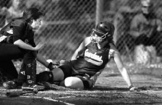 Cara Thompson avoids the tag at home plate in Bainbridge’s 14-2 victory.