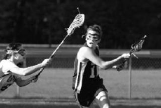 Spartans’ Sally Baumgartner drives down the field Thursday.