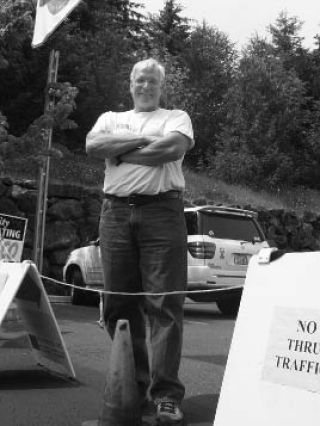 Charlie Frame mans the barricades in the parking lot outside CFA Mortgage