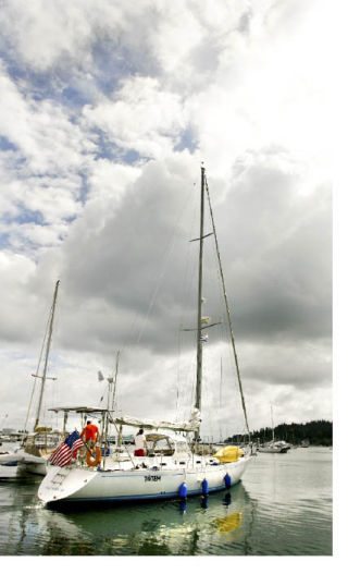 Top: Behan and Jamie Gifford pull away from the marina in their 47-foot sloop