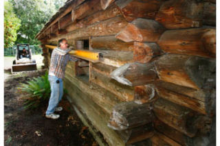 House mover Jeff Monroe secures a support brace on Yeomalt cabin last week.