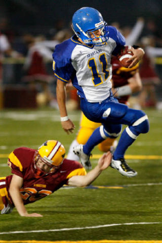 (Clockwise from left) Ross Cobb avoids a tackler en route to the endzone. The senior ran for 191 yards and scored four touchdowns in Bainbridge’s 42-17 win over Kingston Saturday in Poulsbo