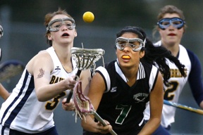 Sydney Whitaker (left) fights for a loose ball with Forest Ridge’s Nisa Orozco-McCormick. The Spartans defeated Tacoma 16-6 on Wednesday to earn a bye in the state playoffs.