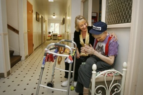 Program manager Wendy Mitchell sits with resident Jack Norris after the busload of residents returned from their outbound activities.