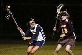 Lucy Schlesser looks to pass in Wednesday’s game against Lakeside. The senior co-captain had seven points off of six goals and one assist as the Spartans defeated the Lions 17-13 at Memorial Stadium.