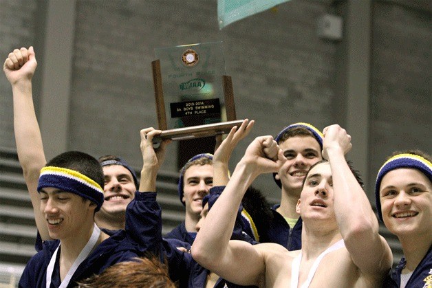 Spartan swimmers hoist their fourth-place trophy after finding themselves on the winners’ platform at the end of the 3A Boys Swimming and Diving Championships.