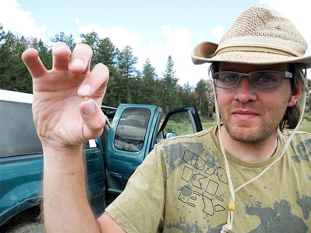 Houston Wade holds a 1-carat Colorado diamond that his crew dug out after working through seven feet of cow dung at one of the “Lost Lakes” in Colorado. The “lake” is more dung than water as cattle daily relieve and refresh themselves at the site.