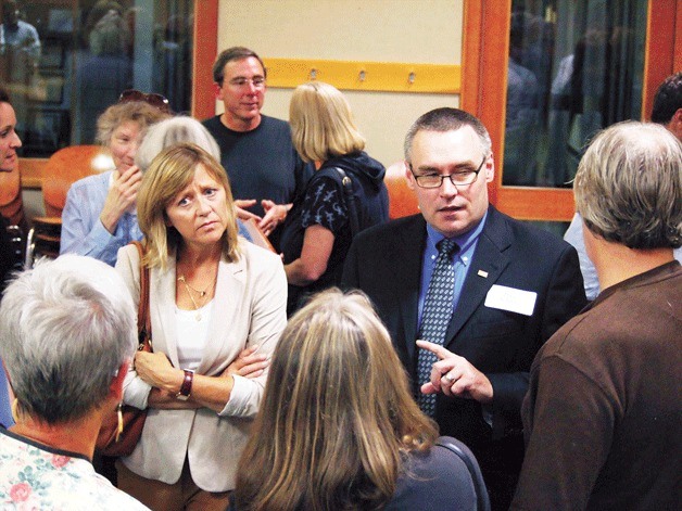 Douglas Schulze speaks with islanders at a reception for the three city manager candidates the night before he was selected.