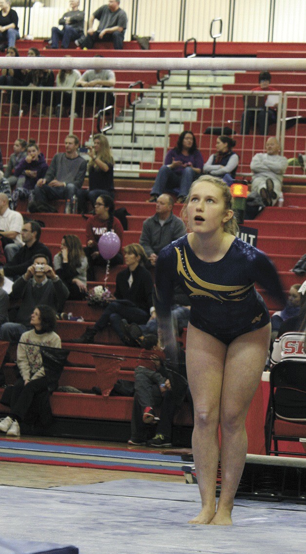 Bainbridge’s Sarah Rice eyes the bars before the start of her routine at the district tournament in Sammamish.