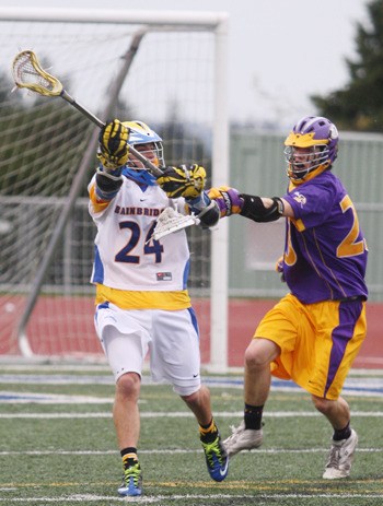 Henry Deery-Schmitt fires a pass off as Issaquah’s Aiden McDonald tries to knock the pass away during Bainbridge's 13-9 win over Issaquah Wednesday in a Division I state semifinal game.