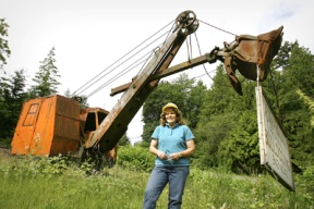 Holly Peterson (top) has transformed the old Peterson property on Miller road into a green waste recycling center. What was once large burn piles are ground into chunks and composted into organic soil for use in gardens and yards. The site has been used by the family since the 1930s.