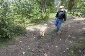 David Snedeker strolls through Pritchard Park with his dog on Thursday