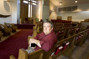 The Rev. Tom Masters in the sanctuary at Rolling Bay Presbyterian Church.