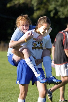 Bainbridge FC GU17 midfielder Hannah Trageser (at left) gives a ride to forward Alex Mynatt during a break in practice. The GU17 team is currently ranked ninth in the state and qualified for the third division of the Washington State Youth Soccer Association Premier League in June. The league starts their season next February.