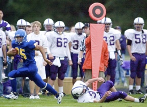 Bainbridge fullback Dayton Gilbreath avoids a North Kitsap defender as he races down the sideline. The senior co-captain rushed for 100 yards and four touchdowns as the Spartans won 41-7.