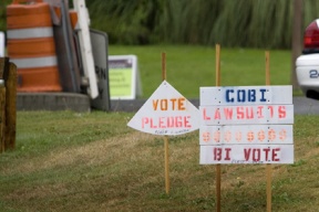 Political signs pepper the lawn outside the Bainbridge police station.