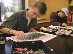 Seniors Grant Twitchell (left) and Alex Watson learn to hand-tint images in Linda Holsman’s advanced photography class.