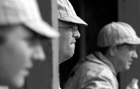 Gavin DeWitt (center) watches the Reds take the field in the fourth inning