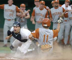 Texas left-fielder Eric Sultemeier slides under a tag by Rice catcher Jeff Blackinton during last Wednesday’s game at the College World Series in Omaha