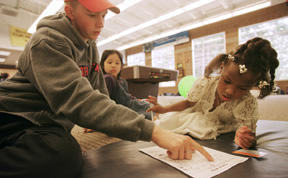 Alexis Goodwyn gets help on her work sheet from Willie Schwab at the new Boys and Girls Club facility at the Bainbridge Aquatic Center.